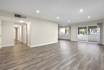 a renovated living room with white walls and wood flooring at White Oak Terrace Apartments, Encino, 91316